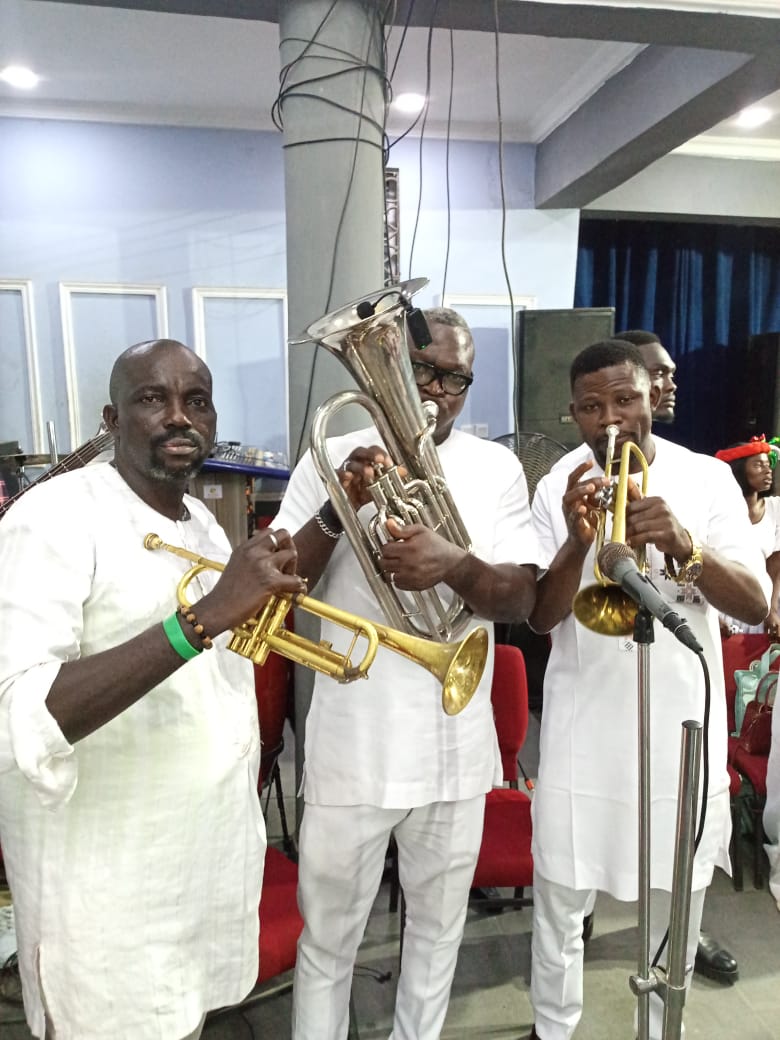 Brass band ensemble with trumpets and euphonium performing at a ceremony