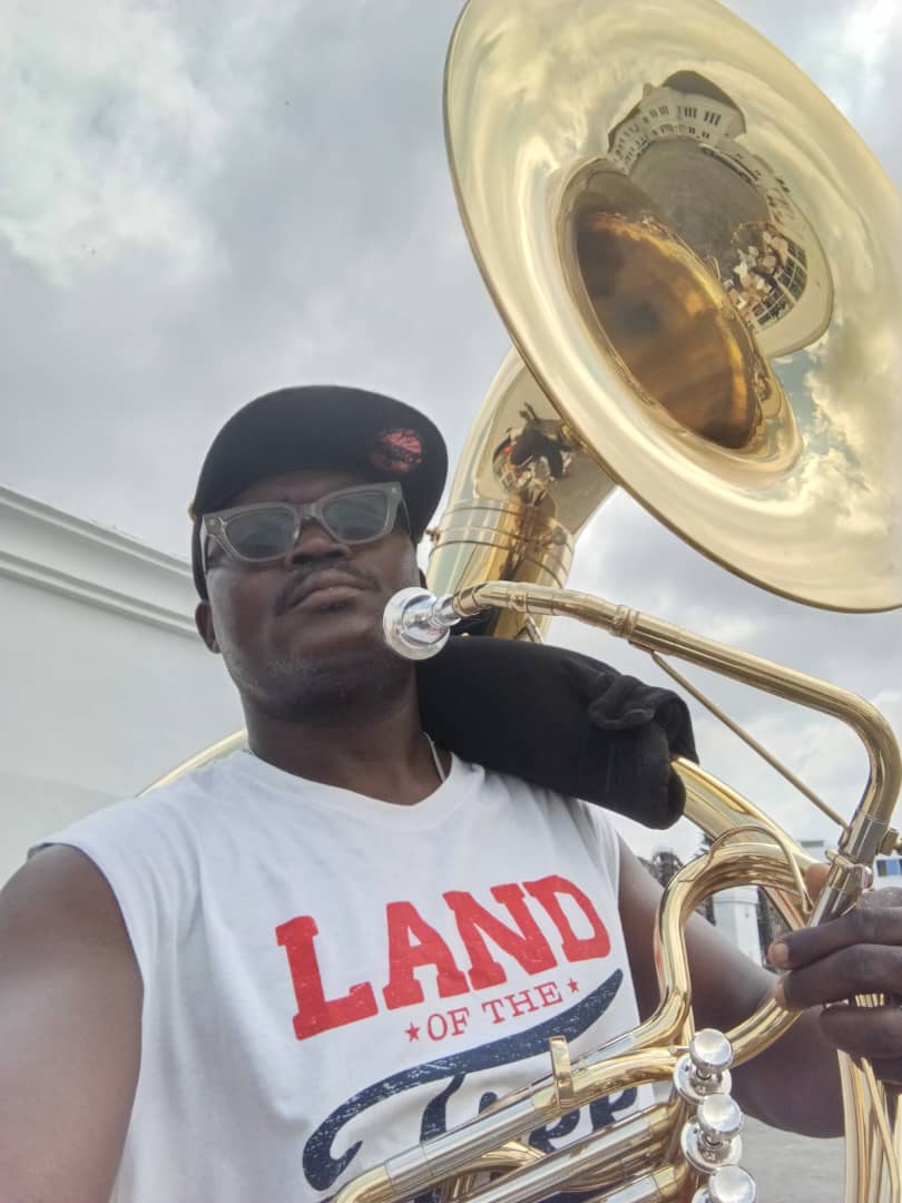 Brass band sousaphone player at an outdoor ceremony